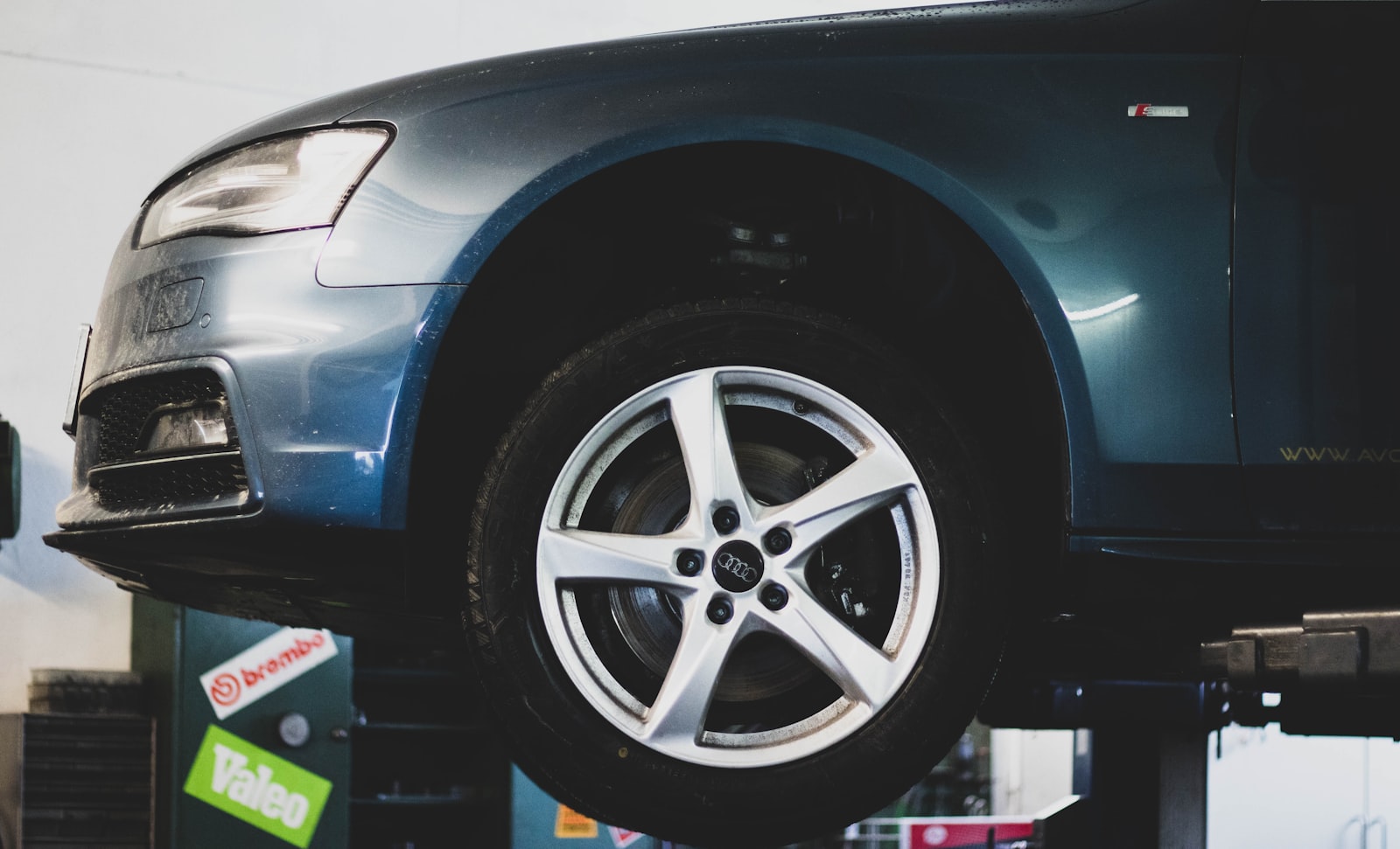 Car on a lift inside an auto repair shop